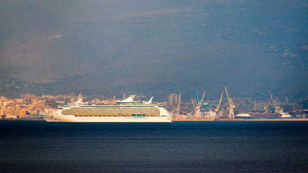A cruise ship enters the port of Palermo